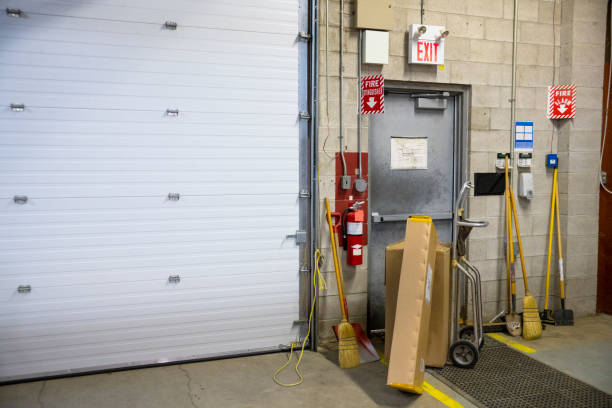 a blocked fire exit door in a warehouse - emergency exit imagens e fotografias de stock