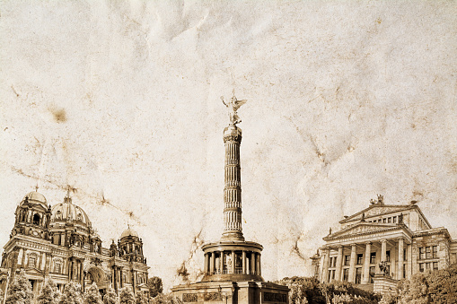 A composition of the famous landmark of Berlin in Germany on an old vintage crumpled paper with space for text at the top. Vintage, grunge, old, retro postcard style photo.