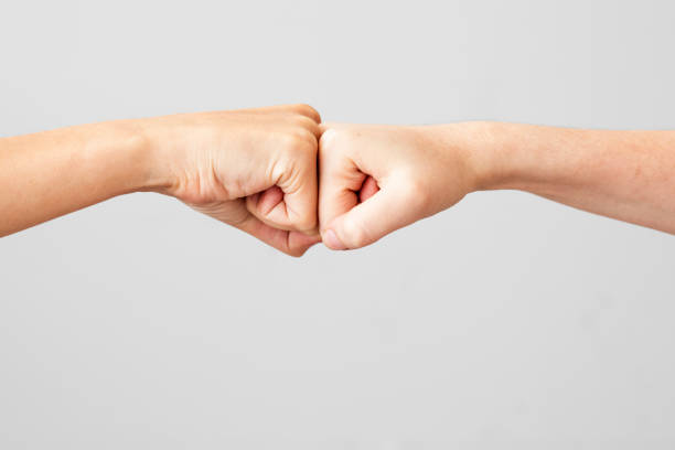 Young people are fist bumping