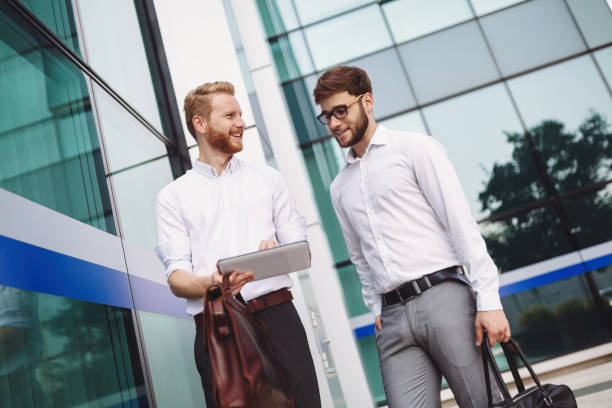 istock Businesspeople looking at tablet outdoors 1029944330