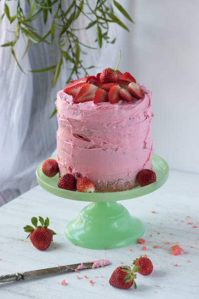 istock pink frosting cake with strawberries 1029949644