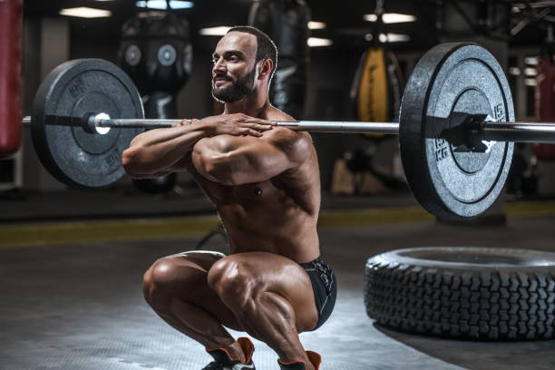 istock Brutal strong bodybuilder athletic men pumping up muscles with dumbbells 1029955096
