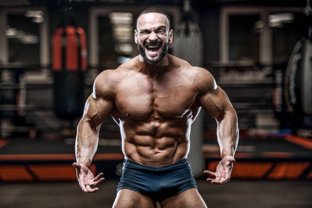 istock Brutal strong bodybuilder athletic men pumping up muscles with dumbbells 1029955668