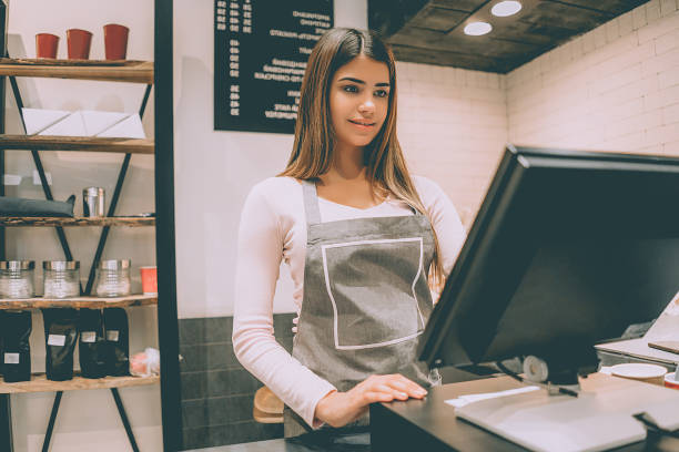 the beautiful cafe worker standing behind the cash register - machine teeth imagens e fotografias de stock