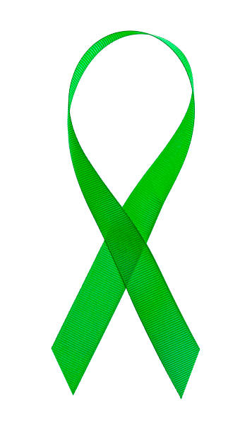 istock Green cancer awareness ribbon on a white background 1029958372