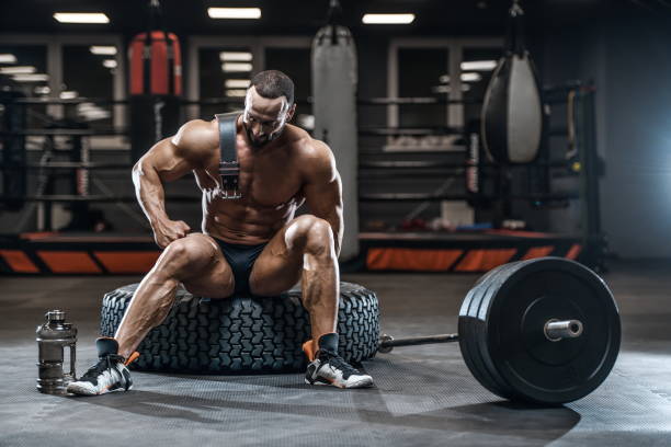 istock Brutal strong bodybuilder athletic men pumping up muscles with dumbbells 1029958728