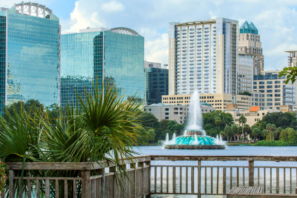 Lake Eola Fountain with Orlando's Skyline View of the Lake Eola Fountain with Orlando's Skyline in the background. lake eola stock pictures, royalty-free photos & images