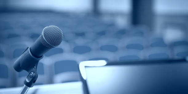 istock Rostrum with microphone and computer in conference room 1029963248