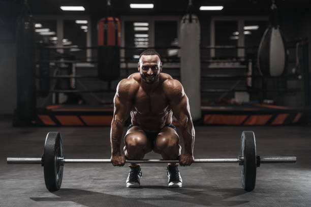 istock Brutal strong bodybuilder athletic men pumping up muscles with dumbbells 1029968648