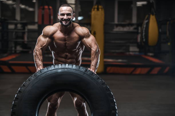 istock Brutal strong bodybuilder athletic men pumping up muscles with dumbbells 1029971114