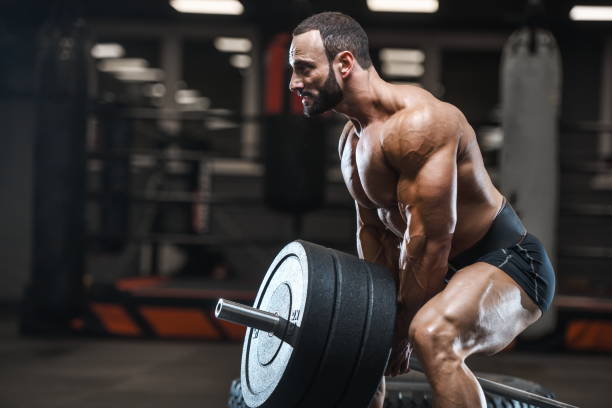 istock Brutal strong bodybuilder athletic men pumping up muscles with dumbbells 1029971532