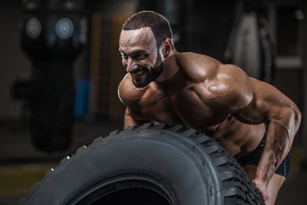 istock Brutal strong bodybuilder athletic men pumping up muscles with dumbbells 1029972026