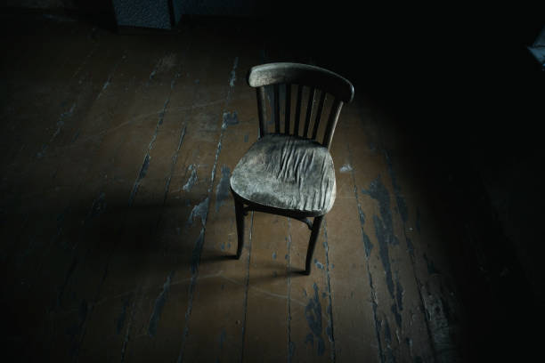 istock Brown wooden  chairs on a dark background 1029975756