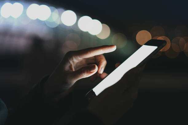 istock Cropped image of woman's hands holding mobile phone with blank copy space screen for your text message or advertising content, female reading news on smartphone while relaxing outdoors. 1029975976