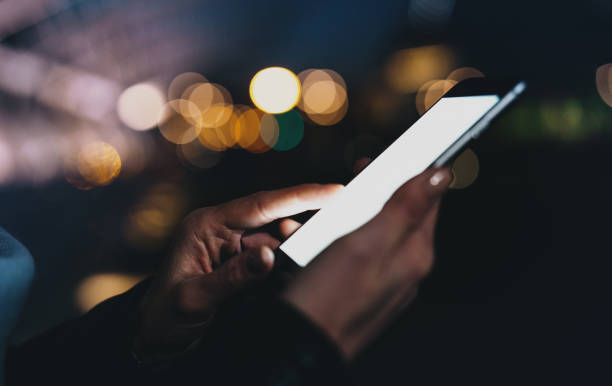 istock Cropped image of woman's hands holding mobile phone with blank copy space screen for your text message or advertising content, female putting down notes on smartphone while relaxing outdoors. 1029975980