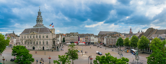 Maastricht, The Netherlands - June 16th 2018, Tourist and locals wander around on the historic 'Markt' square with the town hall in the center of town