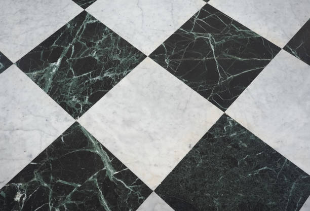 istock chequered white green and black stone floor background 1029998948