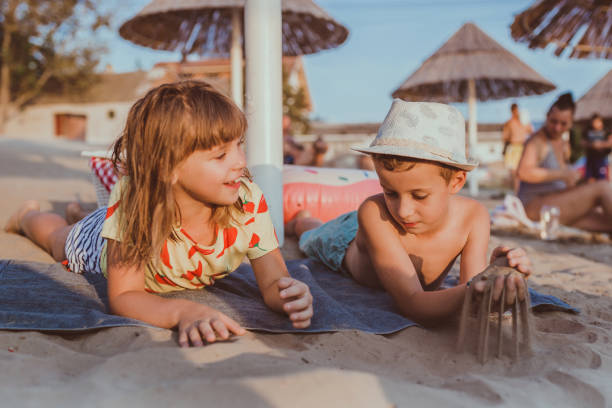 istock Happy positive children and playing with sand 1030001556