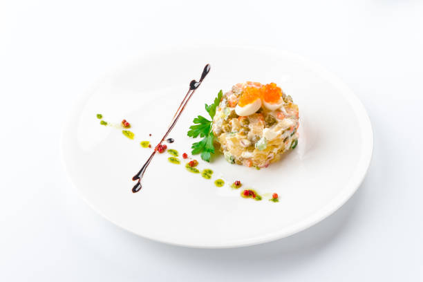 Vegetable salad with ham and mushrooms. Isolated on white background.