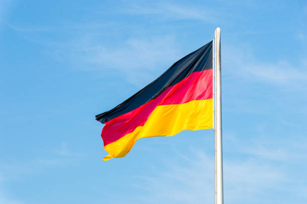 istock German national flag on blue sky. 1030007488