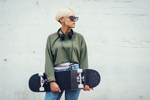 Portrait of blonde woman with headphones and undercut hairstyle