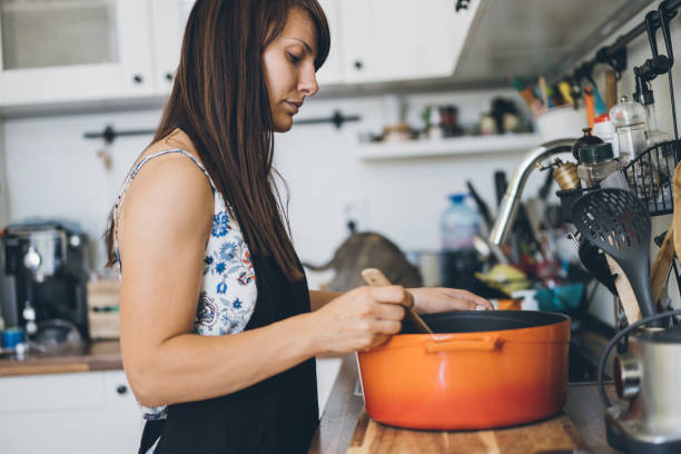 istock Young woman cooking 1030018490