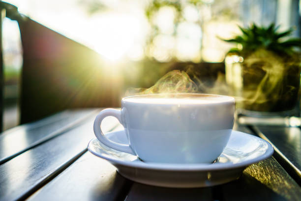 istock Coffee mug with steaming on table with morning lights in UK 1030018890