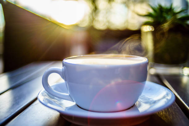 istock Coffee mug with steaming on table with morning lights in UK 1030018896