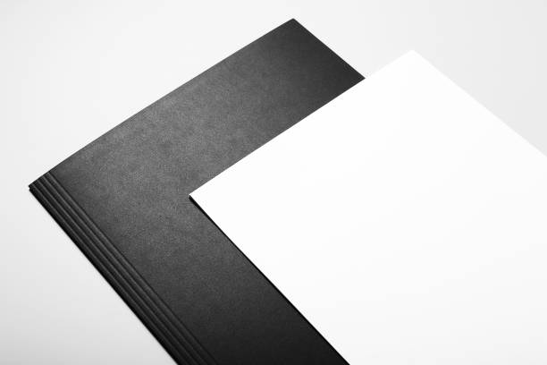istock Blank sheets of paper over black folder 1030021716