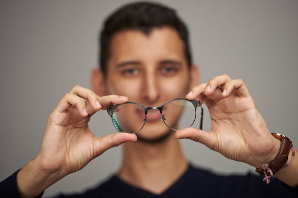 istock Man holding glasses in hands 1030027640