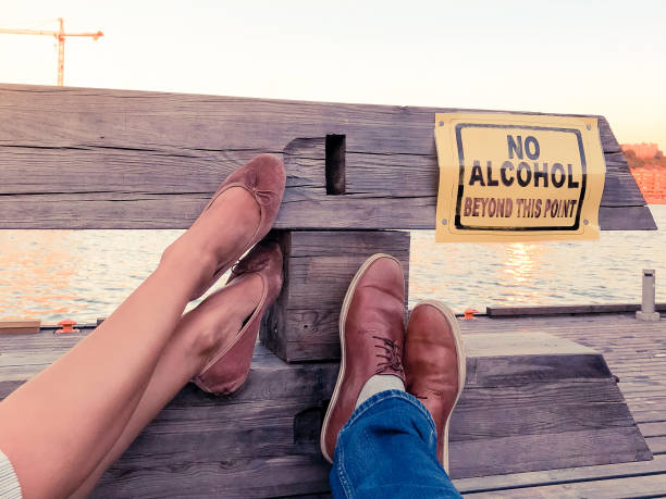 Concept of a young couple decided to stop consuming alcohol Concept of a young couple decided to stop consuming alcohol. Legs of a man and a women pointing to a sign ''No Alcohol beyond this point'' sobriety stock pictures, royalty-free photos & images