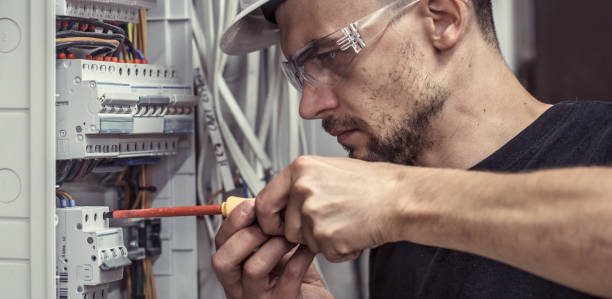 istock a male electrician works in a switchboard with an electrical connecting cable 1030027964