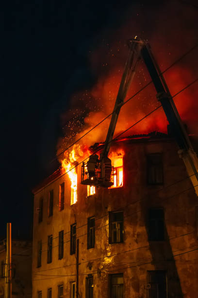 istock Night fire in burning apartment building, firefighters struggle with flame. Fire disaster and accident tragedy 1030030130