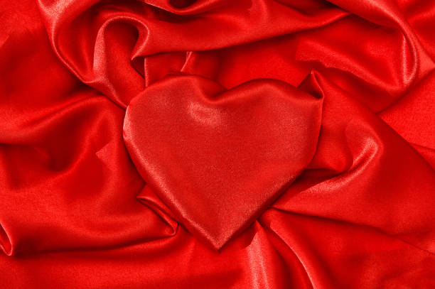 istock Love concept Heart shaped red silk background 1030034816