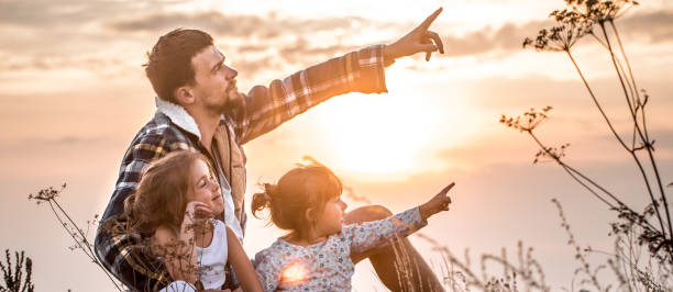 istock dad playing with two little cute daughters 1030035038