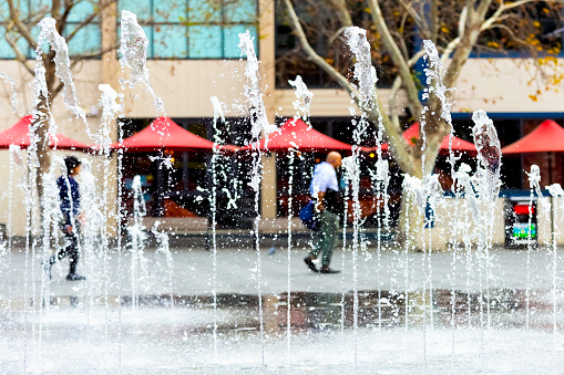 Water fountain in city square, background with copy space, full frame horizontal composition