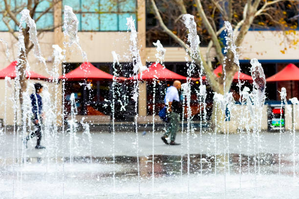 Water fountain in city square, background with copy space Water fountain in city square, background with copy space, full frame horizontal composition shopping mall fountain stock pictures, royalty-free photos & images