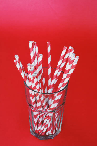 istock Red drinking straws in a glass 1030064348