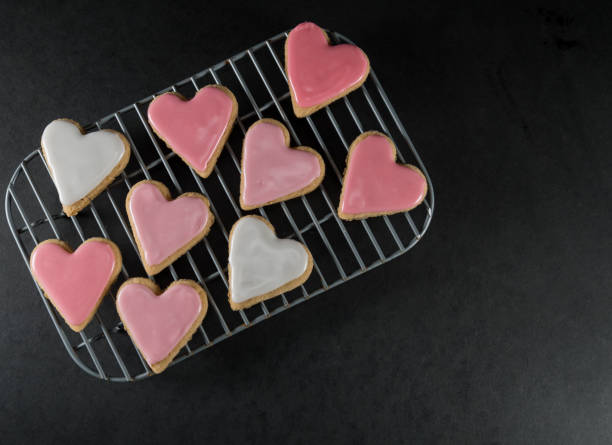 istock Small Frosted Heart Cookies on Cooling Rack 1030069288