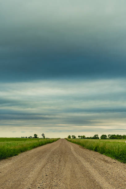 istock Dirt Road Leads to Cloudy Skies 1030069336