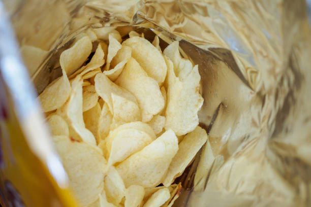 istock Potato chips in open snack bag close up 1030071702