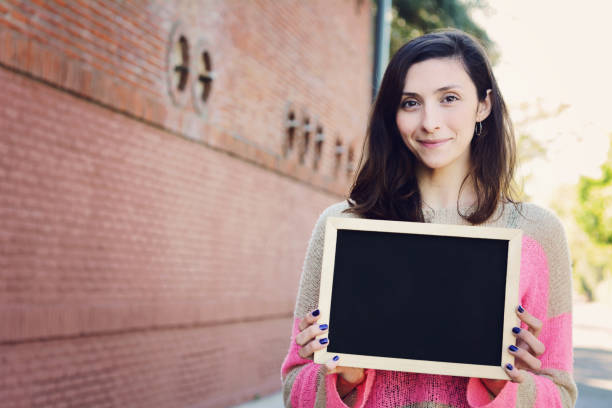 istock Woman holding chalkboard. 1030085370