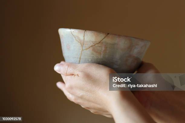 Repair Of Crack Pottery Tea Cup With A Hand Stock Photo - Download Image Now - Kintsugi, Japanese Culture, Japan