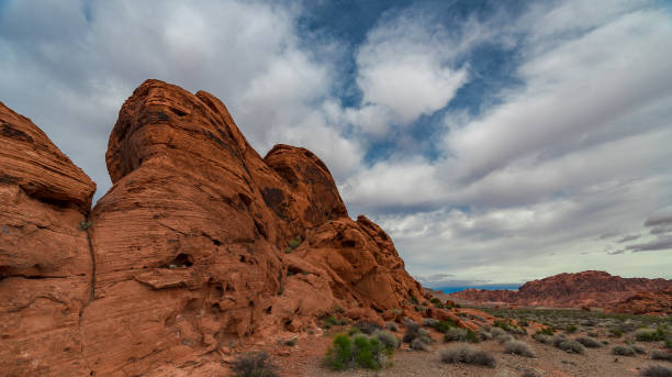 istock Red Sandstone Monuments with Sagebrush in Crevices 1030107342