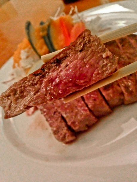 istock Medium rare premium Kobe beef Japanese steak eat with chopsticks 1030117470
