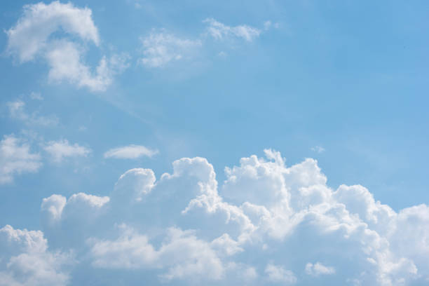 istock Beautiful white fluffy clouds on a blue sky 1030117534