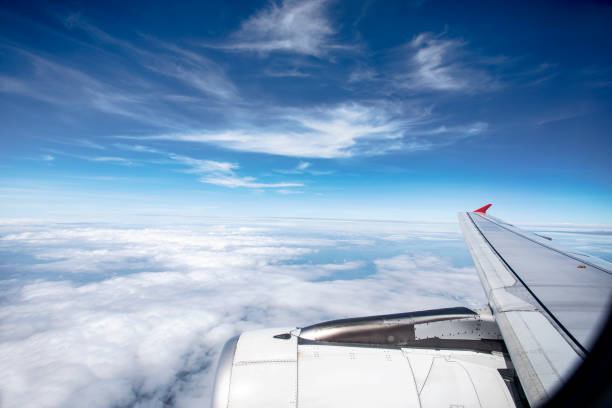 istock through plane window with beautiful white cloud and blue sky 1030122002