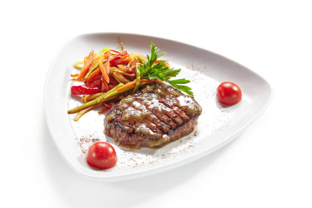 istock Grilled Beef Steak with Vegetables Isolated on White Background 1030122352