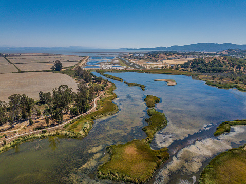 Aerial view of the Bel Marin Keyes in Marin County California. A series of keyes and waterways on a sunny day with a blue sky and aqua water.