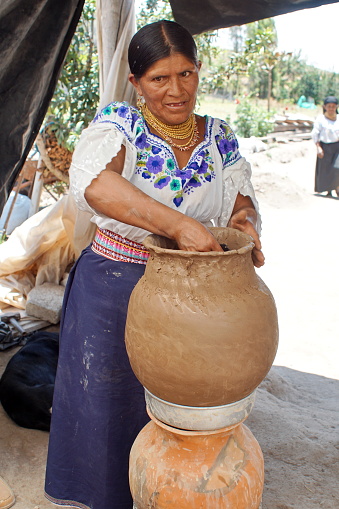 Indigenous woman making a clay pot in a village outside Cotacachi, Ecuador